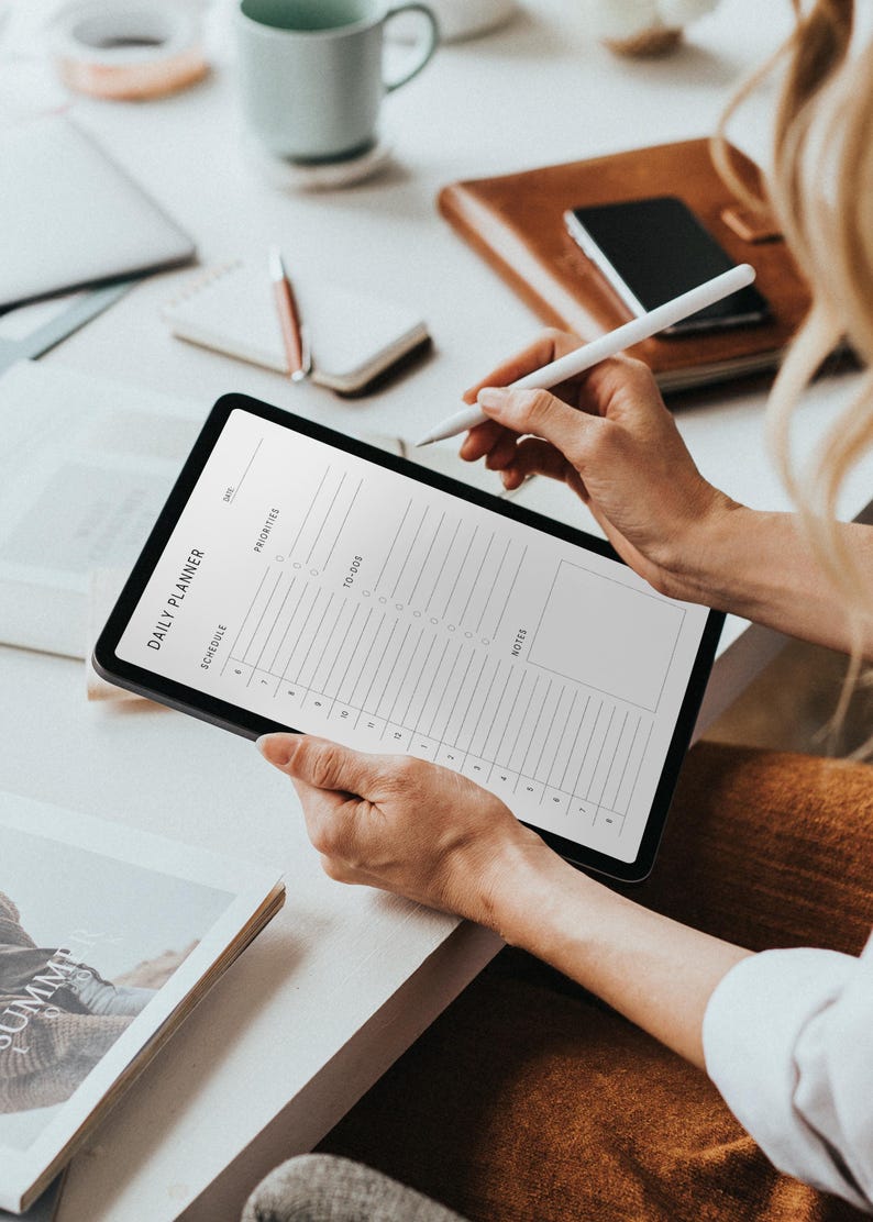 Printed half-letter daily planner sheet featuring a structured schedule layout, task list, and notes area, lying on a flat surface with soft natural lighting and a neutral tone.