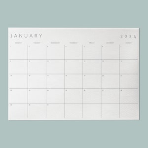 Sleek minimalist monthly planner template set against a soft mint background.