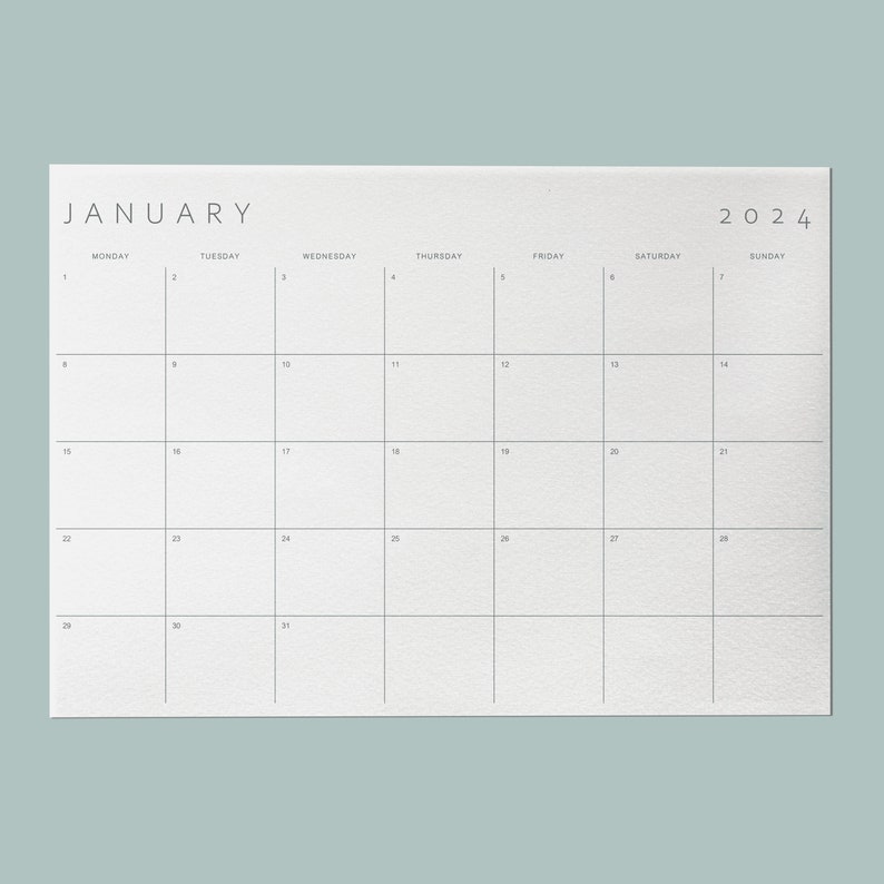 Sleek minimalist monthly planner template set against a soft mint background.