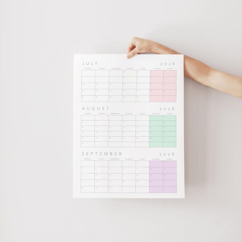May include: A wall calendar for July, August, and September 2026. The calendar features a white background with black text and grid lines. Each month has a distinct color block for the weekend days: pink for July, green for August, and purple for September.