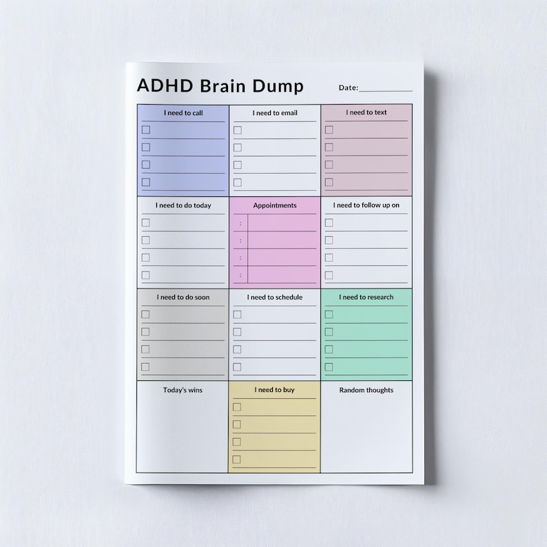 A printed ADHD daily planner on white paper, featuring sections for to-do lists, phone calls, and notes. The sheet is shown on a simple, light-colored surface, allowing the layout to be fully visible.
