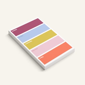 May include: A rectangular notepad featuring five horizontal color-blocked sections in dark pink, light blue, mustard yellow, light pink, and orange. Each section is labeled with the days of the week: Monday, Tuesday, Wednesday, Thursday, and Friday.