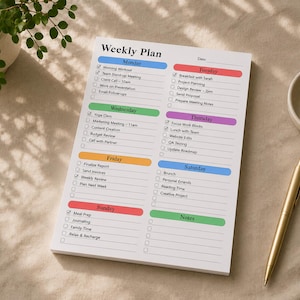 Large planner notepad with structured weekly checklist design photographed on beige desk background, featuring lined scheduling areas, pastel weekday labels and clean workspace planning layout.