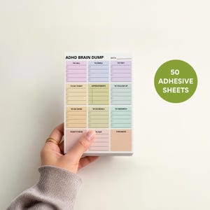 Structured ADHD-friendly sticky note pad in 4x6in with rainbow pastel sections, checkboxes, space for tasks, reminders, ideas, and notes, designed for executive function support.