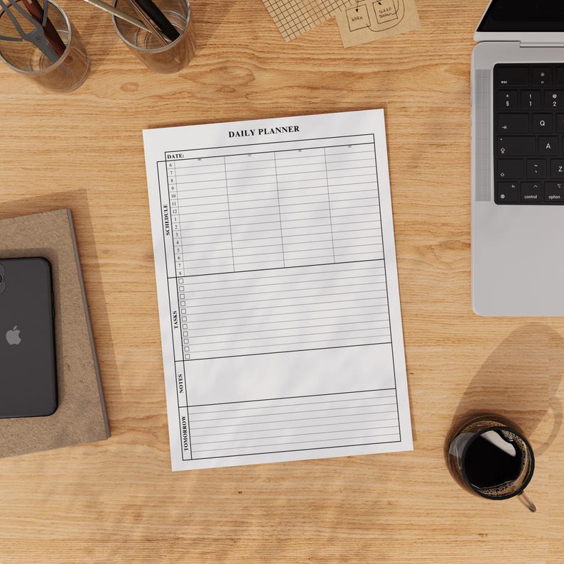 Digital daily planner PDF displayed on a clean desk, showing sections for schedule, todos, notes, and tomorrow’s priorities.