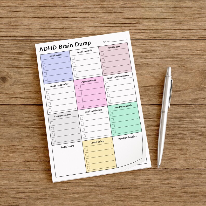 A person holding a 4x6 inch ADHD planner sticky note sheet, showing a structured daily layout with visually distinct sections for notes, tasks, calls, and appointments on matte white paper.