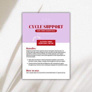 May include: A product information card with the text "CYCLE SUPPORT" in red, promoting relief from premenstrual symptoms. The card has a light purple background with white text detailing benefits and usage instructions. The words "Her Core Essentials" are also visible.