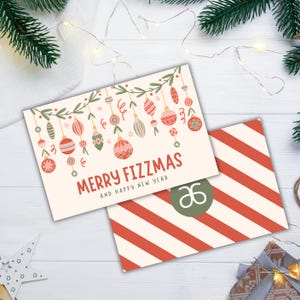 May include: A Christmas card with a festive design featuring a garland of ornaments and the text "Merry Fizzmas and Happy New Year". The card is decorated with a green and white striped pattern.