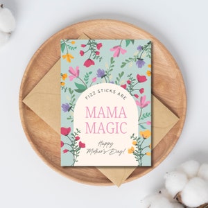 Pode incluir: Um cartão azul claro com um padrão floral e o texto "Fizz sticks are Mama Magic. Happy Mother's Day!"