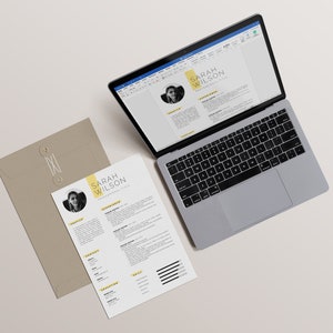 May include: A laptop computer with a resume open on the screen. The resume is for Sarah Wilson and features a professional headshot. A printed copy of the resume is on a beige envelope.