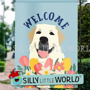 May include: Welcome garden flag featuring a white Labrador Retriever with a pink tongue sticking out, surrounded by colorful flowers. The flag has a blue background with the word "WELCOME" in white letters. The flag is made by Silly Little World.