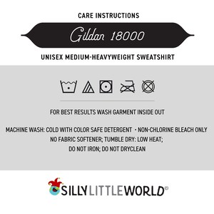 May include: Care instructions for a Gildan 18000 unisex medium-heavyweight sweatshirt. The instructions include machine wash cold with color safe detergent, non-chlorine bleach only, no fabric softener, tumble dry low heat, do not iron, and do not dry clean.