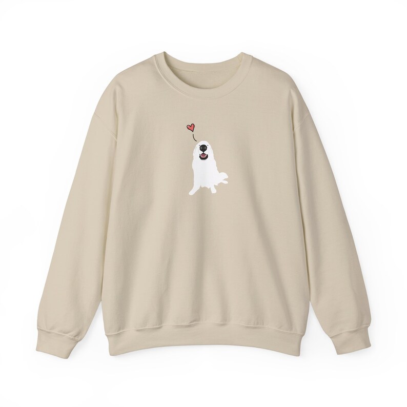 May include: A beige sweatshirt featuring a white dog illustration with a red heart above its head.