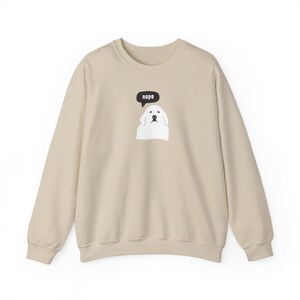 May include: A beige sweatshirt with a white dog wearing a speech bubble that says "nope".