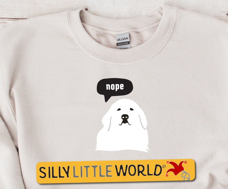 May include: White sweatshirt with a cartoon white dog with a speech bubble that says "nope". The text "SILLY LITTLE WORLD" is printed in yellow at the bottom of the sweatshirt.