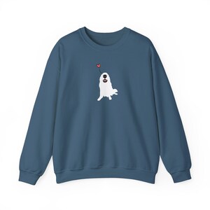 May include: A dark blue sweatshirt featuring a white illustration of a dog looking up at a red heart.