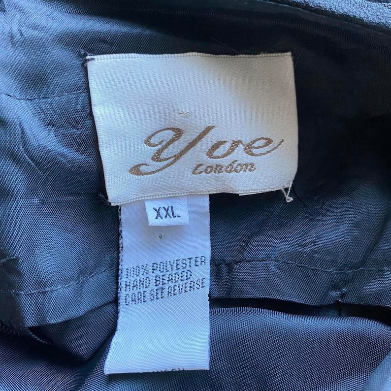 May include: A black label with white text that reads "Yve London" and "XXL". The label also says "100% Polyester Hand Beaded Care See Reverse".