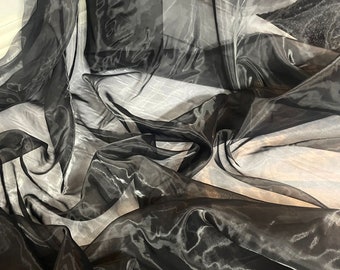 May include: Black sheer fabric with a crinkled texture. The fabric is translucent and has a slight sheen.