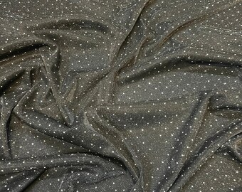 May include: Black fabric with a subtle shimmer and small white dots. The fabric is wrinkled and has a textured surface.