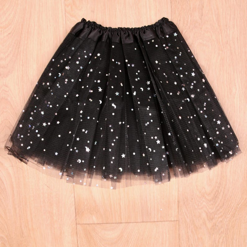 Black 3 layered tulle girls tutu covered in glittering silver stars.