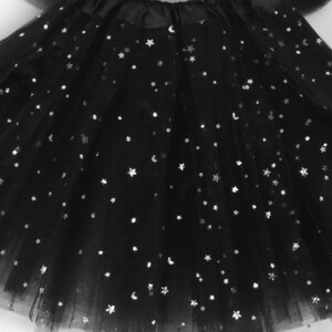 Black tulle tutu covered with silver stars.