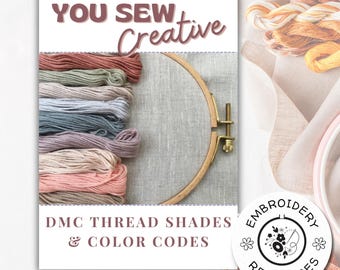 May include: A white card with the text "You Sew Creative" in brown lettering. The card features a close-up of a wooden embroidery hoop with a variety of DMC embroidery floss spools in shades of pink, peach, beige, gray, and blue. The text "DMC Thread Shades & Color Codes" is printed below the hoop. A circular logo with the text "Embroidery Resources" is in the bottom right corner.