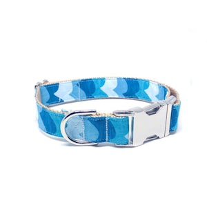 May include: A blue and white patterned dog collar with a silver buckle and D-ring.