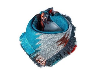 May include: A turquoise, gray, and orange patterned bandana with fringed edges.