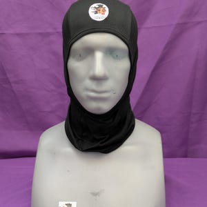 May include: Black balaclava with a small logo on the front. The logo is a circle with a cartoon dragon inside.