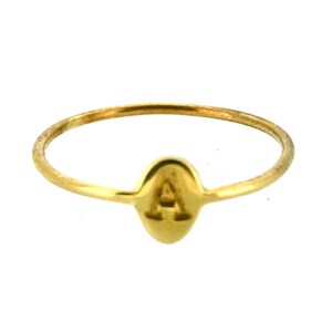May include: A slender gold ring with the letter "A" displayed on a small, oval charm. The ring has a thin band and a polished finish, offering a simple and elegant appearance. This piece of jewellery is suitable for everyday wear.