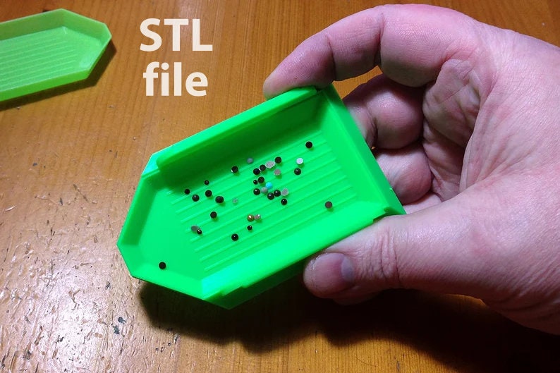 May include: Green plastic tray with a grid pattern and a small amount of colorful beads inside. The tray is labeled "STL file".
