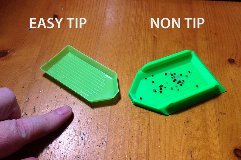 May include: Two green diamond painting trays, one labeled "EASY TIP" and the other labeled "NON TIP". The tray labeled "EASY TIP" has a ridged surface, while the tray labeled "NON TIP" has a smooth surface.