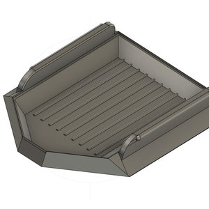 May include: A gray metal construction bucket with a hinged side and a textured bottom. The bucket is designed for lifting and carrying materials.
