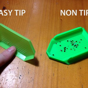 May include: Two green diamond painting trays, one labeled "EASY TIP" and the other labeled "NON TIP". The tray labeled "EASY TIP" has a raised edge to prevent diamonds from spilling. The tray labeled "NON TIP" does not have a raised edge.