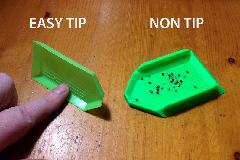 May include: Two green diamond painting trays, one labeled "EASY TIP" and the other labeled "NON TIP". The tray labeled "EASY TIP" has a raised edge to prevent diamonds from spilling. The tray labeled "NON TIP" does not have a raised edge.