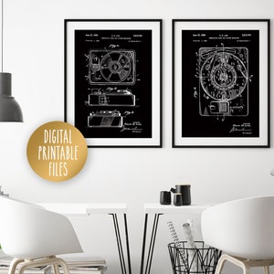 May include: Two black and white vintage patent prints of a record player and a tape recorder. The prints are framed in black frames and are hanging on a white wall. The text on the prints reads "Magnetic Tape Recording Apparatus" and "Magnetic Tape Recording Apparatus".