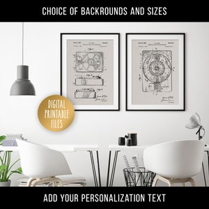 May include: Two black framed prints of vintage record player patent drawings on a white wall. The drawings are in black and white and show the different parts of the record player. The text on the drawings includes the patent number and date. The prints are hanging above a white desk with a white chair and a black lamp.