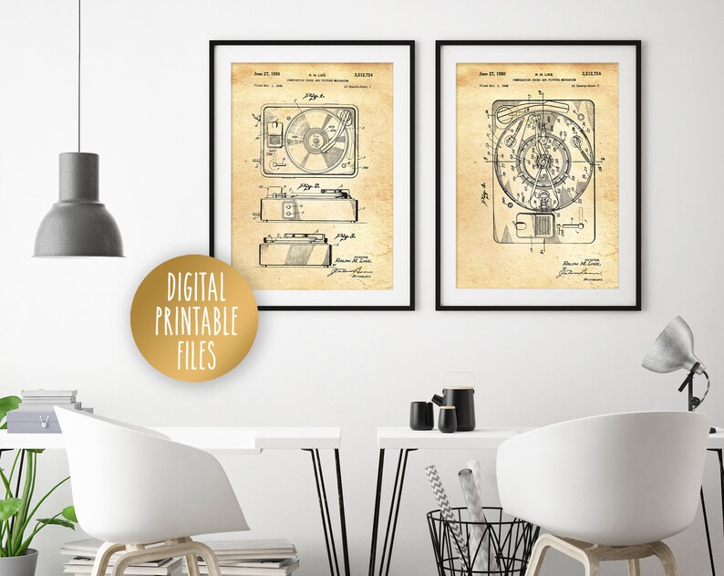 May include: Two vintage black and white patent drawings of record players. The drawings are framed and hung on a white wall. The drawings are on a beige background with black lines.
