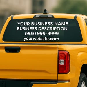May include: A yellow pickup truck with a rear window decal. The decal displays the text "YOUR BUSINESS NAME," "BUSINESS DESCRIPTION," a phone number, and a website address in white font.