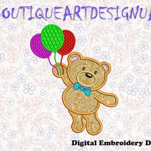 May include: A gold glitter teddy bear holding three balloons. The balloons are purple, green, and red. The teddy bear is wearing a blue bow tie. The background is a white floral pattern.