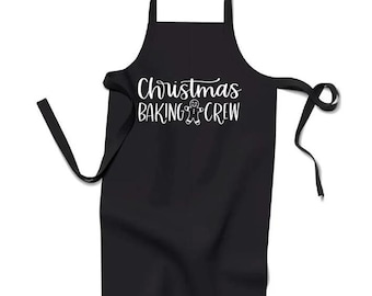 May include: Black apron with white text that reads "Christmas Baking Crew" and a gingerbread man graphic.