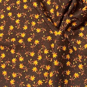 May include: Brown fabric with a repeating pattern of yellow and orange leaves and small red dots. The fabric has a white border with the text "for BENARTEX LLC www.benar"