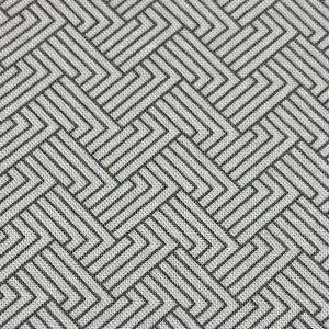 May include: Close-up of a woven fabric with a geometric pattern. The design features interlocking lines in shades of gray and black, creating a textured, repeating motif. The fabric has a subtle, neutral color palette.