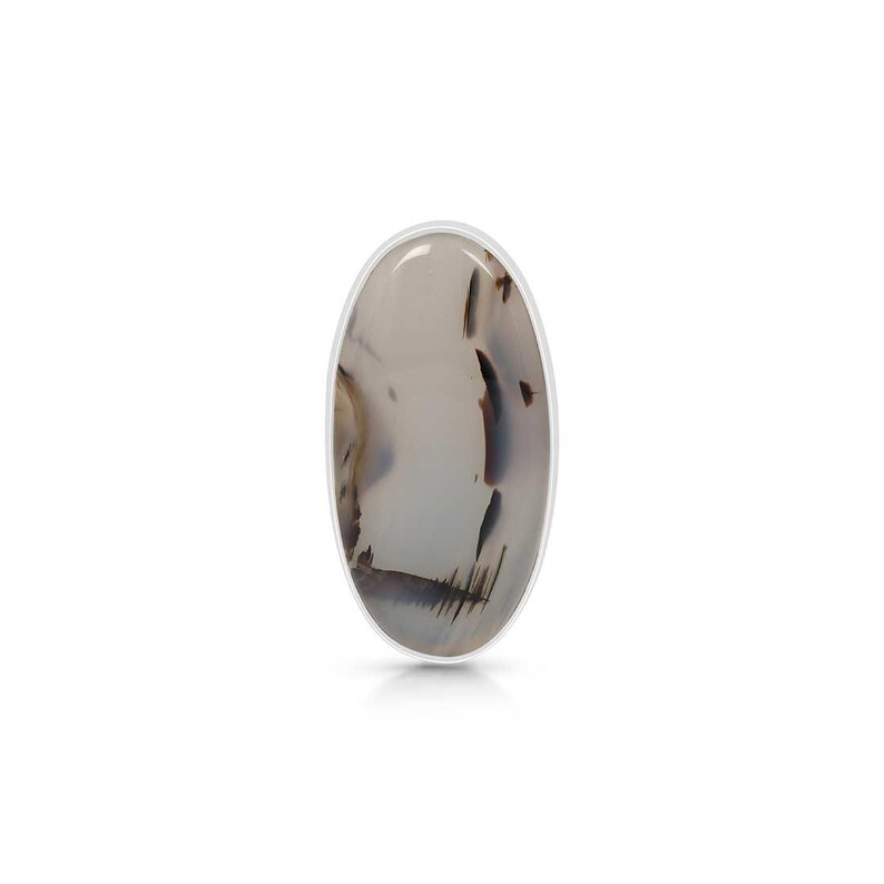 May include: A silver ring with a white oval agate stone featuring brown and gray patterns.