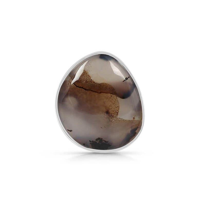 May include: A silver ring with a brown and white agate stone. The stone has a unique pattern of swirls and lines.