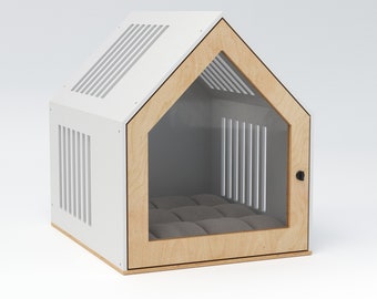 May include: A modern pet house in the shape of a house. The structure is white with a natural wood frame and a clear front door. The roof has ventilation slats. Inside is a gray cushion for comfort.