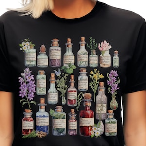 May include: A black t-shirt with a colorful illustration of various glass bottles filled with liquids and herbs. The bottles have labels with handwritten text and are surrounded by flowers and plants.