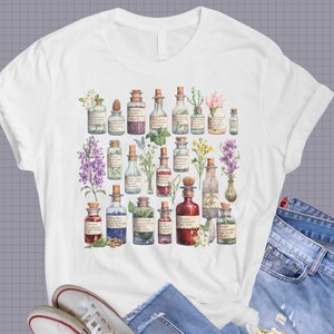 May include: White t-shirt with a vintage illustration of various glass bottles filled with colorful liquids and surrounded by flowers and plants.