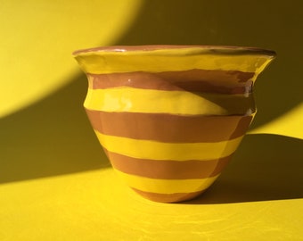 Terracotta vase with yellow stripes