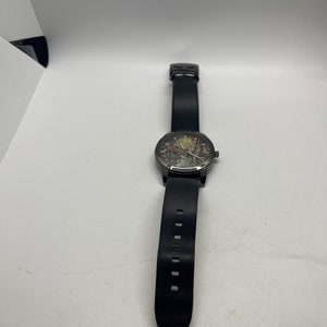 May include: A black leather wristwatch with a black face and silver hands. The watch has a black leather strap with a pointed end.